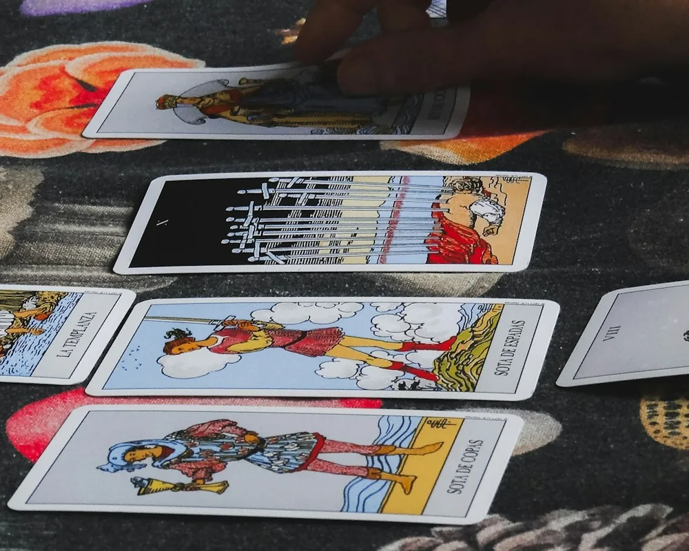 Reading a physical spread: cards and the reader's hand on a table